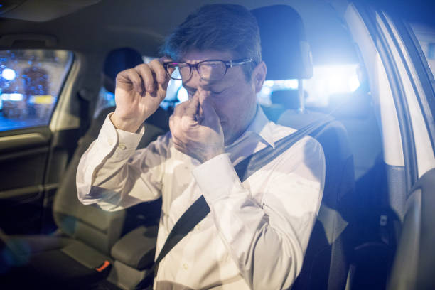 Tired driver inside car at night